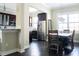 Inviting dining area with a wooden table set, chandelier lighting, and stainless steel appliances visible from the kitchen at 2575 W Platt St, Tampa, FL 33609