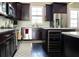 Modern kitchen featuring stainless steel appliances, dark wood cabinets, and marble countertops at 2575 W Platt St, Tampa, FL 33609