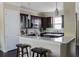 Stylish kitchen with dark wood cabinets, marble countertops, and a convenient breakfast bar with seating at 2575 W Platt St, Tampa, FL 33609