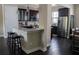 Open-concept kitchen with dark wood cabinets, stainless steel appliances, and a bar overlooking the dining area at 2575 W Platt St, Tampa, FL 33609