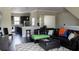Inviting living room with dark wood floors, a leather sofa, and seamless connectivity to the kitchen and dining areas at 2575 W Platt St, Tampa, FL 33609