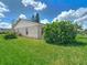 Well-maintained backyard with healthy lawn, mature landscaping, and a view of the home's rear exterior at 2937 Stilwell Ct, New Port Richey, FL 34655