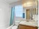 Well-lit bathroom featuring a tub with shower, vanity with sink, and window with natural light at 2937 Stilwell Ct, New Port Richey, FL 34655
