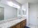 Bathroom features a vanity with sink, large mirror, and shower at 2937 Stilwell Ct, New Port Richey, FL 34655
