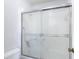 Bathroom shower with sliding glass doors and white tile at 2937 Stilwell Ct, New Port Richey, FL 34655
