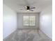 Bedroom featuring neutral carpet, a window with natural light, and ceiling fan at 2937 Stilwell Ct, New Port Richey, FL 34655