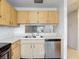 Functional kitchen featuring ample cabinet space, stainless steel dishwasher and double sink at 2937 Stilwell Ct, New Port Richey, FL 34655