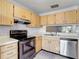 Functional kitchen featuring ample cabinet space, stainless steel appliances and double sink at 2937 Stilwell Ct, New Port Richey, FL 34655