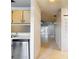 Kitchenette with stainless steel appliances and tile flooring leading to a sunny living area at 2937 Stilwell Ct, New Port Richey, FL 34655
