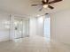 Spacious living room with neutral tile flooring and sliding glass doors to a sunroom at 2937 Stilwell Ct, New Port Richey, FL 34655
