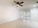 Spacious living room with neutral tile flooring and sliding glass doors to a sunroom at 2937 Stilwell Ct, New Port Richey, FL 34655