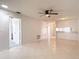 Spacious living room with ceiling fan, tile flooring, and freshly painted walls at 2937 Stilwell Ct, New Port Richey, FL 34655
