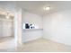 Bright living room with tile floors, a view into the kitchen, and fresh white paint at 2937 Stilwell Ct, New Port Richey, FL 34655