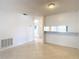 Open living room featuring tile flooring, white walls, and access to other rooms at 2937 Stilwell Ct, New Port Richey, FL 34655