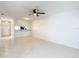 Bright living room with tile floors, a view into the kitchen, and fresh white paint at 2937 Stilwell Ct, New Port Richey, FL 34655