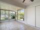 Bright sunroom with tile floors and large windows, offering views of the landscaped backyard at 2937 Stilwell Ct, New Port Richey, FL 34655