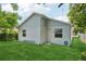 View of the back of the home highlighting the siding and well-manicured lawn at 3114 E 21St Ave, Tampa, FL 33605