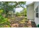 Spacious backyard featuring a wooden fence and mature trees, offering privacy and a natural setting at 3114 E 21St Ave, Tampa, FL 33605