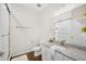 A well-lit bathroom features a tiled glass shower and granite countertop on the white vanity at 3114 E 21St Ave, Tampa, FL 33605
