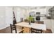 Well-lit dining area with a light wood table, seating, and modern kitchen appliances at 3114 E 21St Ave, Tampa, FL 33605