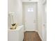Bright entryway featuring wood floors, a white storage console with an orchid, and front door with window at 3114 E 21St Ave, Tampa, FL 33605