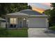 Charming single-Gathering home featuring a two-car garage, welcoming front porch, and manicured lawn at 3114 E 21St Ave, Tampa, FL 33605