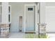 Inviting front porch with stacked stone detail and a 'WELCOME' sign adds character to this home's entrance at 3114 E 21St Ave, Tampa, FL 33605