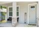 Inviting front porch with seating area and a 'WELCOME' sign adds character to this home's entrance at 3114 E 21St Ave, Tampa, FL 33605