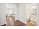 Hallway view showcasing wood-look flooring, leading to the living room and a half bathroom with white vanity at 3114 E 21St Ave, Tampa, FL 33605
