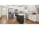 Spacious kitchen with stainless steel appliances, granite countertops, white cabinets and rolling island at 3114 E 21St Ave, Tampa, FL 33605