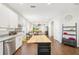 Kitchen view showcasing granite countertops, stainless steel appliances and an island, opening into the living space at 3114 E 21St Ave, Tampa, FL 33605