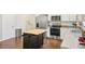Well-equipped kitchen featuring stainless steel appliances, granite counters and rolling kitchen island at 3114 E 21St Ave, Tampa, FL 33605