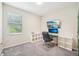 A well-lit office featuring carpeted floors, a large window, shelving, and a workstation at 3114 E 21St Ave, Tampa, FL 33605