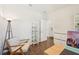 Home office area featuring wood-look floors, a desk, chair, and decorative shelving at 3114 E 21St Ave, Tampa, FL 33605