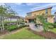 Spacious backyard featuring a patio area with outdoor furniture, lush greenery, and a pergola at 32203 Mahogany Valley Dr, Wesley Chapel, FL 33543