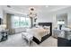 Spacious bedroom with a large window, stylish furnishings, and neutral decor at 32203 Mahogany Valley Dr, Wesley Chapel, FL 33543