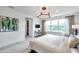 Bright bedroom with a large window, contemporary lighting, and modern decor at 32203 Mahogany Valley Dr, Wesley Chapel, FL 33543