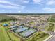 Aerial shot showcases tennis courts, clubhouse, and parking area in the community at 32203 Mahogany Valley Dr, Wesley Chapel, FL 33543