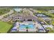 Community pool with a splash pad, lounge chairs, and seating areas at 32203 Mahogany Valley Dr, Wesley Chapel, FL 33543