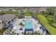 Aerial view of community pool with lounge chairs, cabanas, and tropical landscaping at 32203 Mahogany Valley Dr, Wesley Chapel, FL 33543