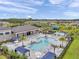 Aerial view of community pool with lounge chairs, picnic tables and splash pad at 32203 Mahogany Valley Dr, Wesley Chapel, FL 33543