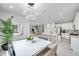 Open concept layout with the dining area adjacent to a modern kitchen and living area at 32203 Mahogany Valley Dr, Wesley Chapel, FL 33543
