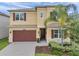 Two-story home with a two-car garage and professionally landscaped yard at 32203 Mahogany Valley Dr, Wesley Chapel, FL 33543
