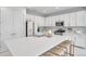 Bright, modern kitchen with stainless steel appliances, a large center island, and white cabinets at 32203 Mahogany Valley Dr, Wesley Chapel, FL 33543
