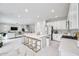Bright open-concept kitchen with a large island, modern white cabinetry, and stainless steel appliances at 32203 Mahogany Valley Dr, Wesley Chapel, FL 33543