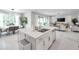 Modern, open concept kitchen featuring stainless appliances, center island, and dining and living spaces at 32203 Mahogany Valley Dr, Wesley Chapel, FL 33543