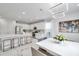 Bright kitchen with an eat-in island, modern stainless steel appliances, and a view into the dining room at 32203 Mahogany Valley Dr, Wesley Chapel, FL 33543