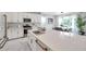 Modern eat-in kitchen with stainless steel appliances, quartz countertops, and dining area with a beautiful window view at 32203 Mahogany Valley Dr, Wesley Chapel, FL 33543