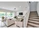 Bright living room with modern lighting, sleek furniture, and seamless access to an outdoor patio area at 32203 Mahogany Valley Dr, Wesley Chapel, FL 33543