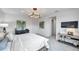 Bright main bedroom featuring gray carpet, a modern light fixture, and stylish decor at 32203 Mahogany Valley Dr, Wesley Chapel, FL 33543